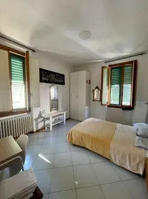 Letto o letti in una camera di Appartamento in San Donato Novoli a poca distanza dalla Tranvia