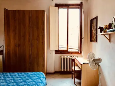 Letto o letti in una camera di Appartamento in San Donato Novoli a poca distanza dalla Tranvia