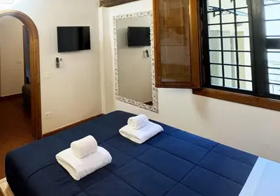 Letto o letti in una camera di Casa di Ciapa - Boutique Apt nel cuore di Firenze