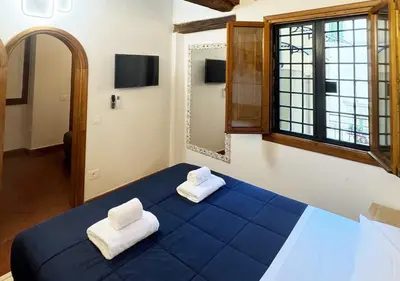 Letto o letti in una camera di Casa di Ciapa - Boutique Apt nel cuore di Firenze