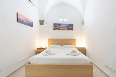 Letto o letti in una camera di I Santa Croce I Conciatori Prestige Home Apartment