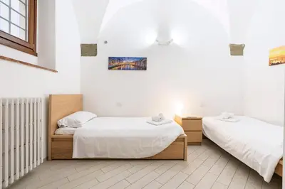 Letto o letti in una camera di I Santa Croce I Conciatori Prestige Home Apartment