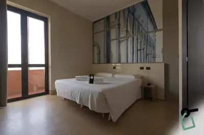 Letto o letti in una camera di Hotiday Firenze Guidoni