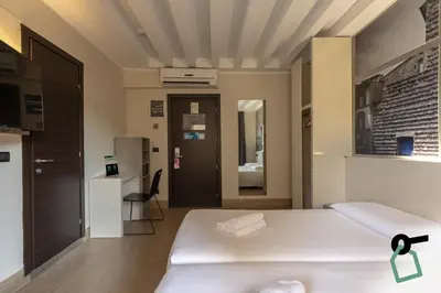 Letto o letti in una camera di Hotiday Firenze Guidoni