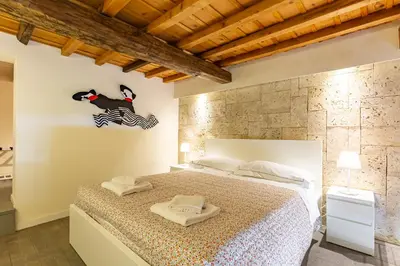Letto o letti in una camera di GuestHost - Boutique House Porta Romana