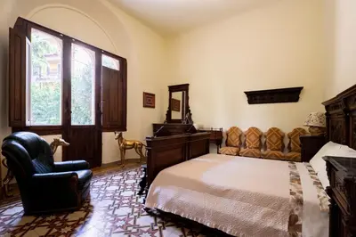 Letto o letti in una camera di Villa dell'Artista - Camere con bagno privato in Villa storica