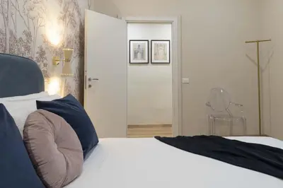 Letto o letti in una camera di Pallottole Duomo Apartments