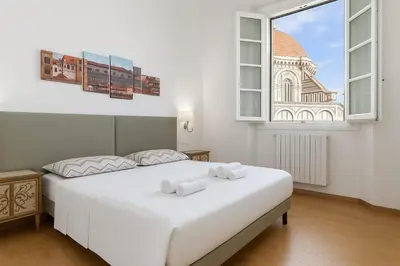 Letto o letti in una camera di Pallottole Duomo Apartments