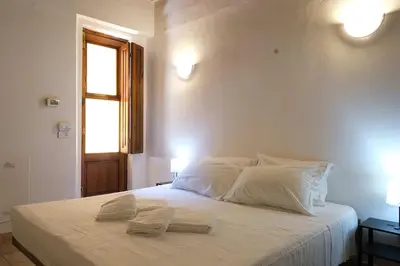 Letto o letti in una camera di Wine Apartments Florence Sagrantino