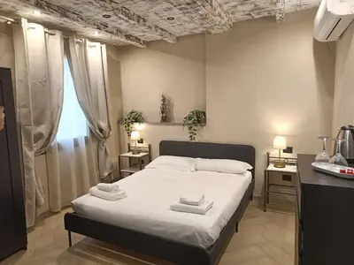 Letto o letti in una camera di BNB Frescoes Rooms San Frediano