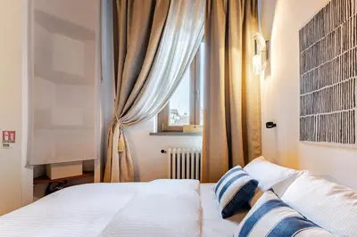 Letto o letti in una camera di Sui Tetti di Chiasso Perduto