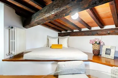 Letto o letti in una camera di Sui Tetti di Chiasso Perduto