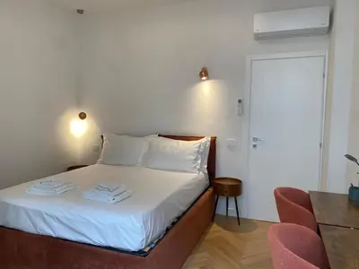 Letto o letti in una camera di Duomo Giglio Viola