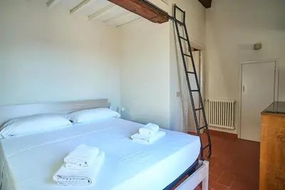 Letto o letti in una camera di Appartamento di charme con terrazza