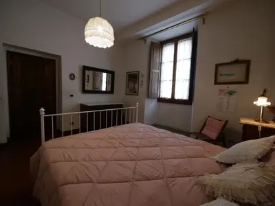 Letto o letti in una camera di Alloggiare nei luoghi dove é vissuto Dante