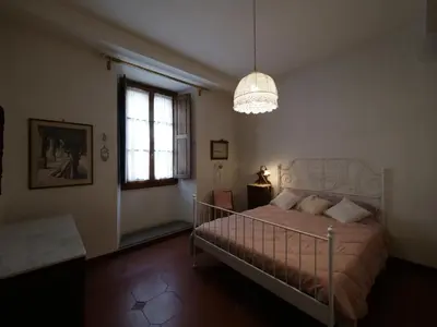 Letto o letti in una camera di Alloggiare nei luoghi dove é vissuto Dante
