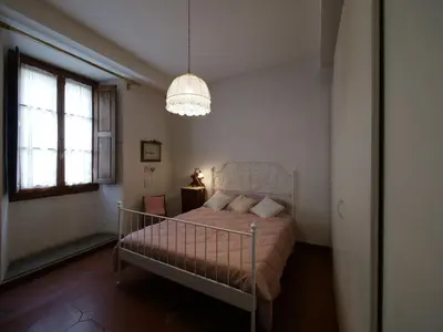 Letto o letti in una camera di Alloggiare nei luoghi dove é vissuto Dante