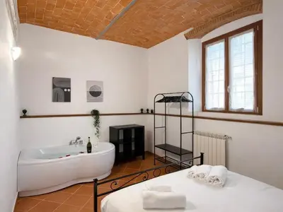 Letto o letti in una camera di Oasis Apartment, Vasca Idromassaggio e Parcheggio