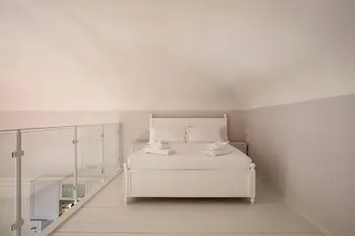 Letto o letti in una camera di Palazzo Galli Tassi Collection - Loft 2