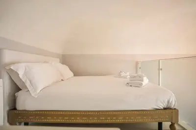 Letto o letti in una camera di Palazzo Galli Tassi Collection - Loft 2 & Loft 3