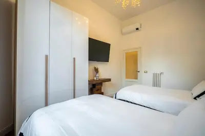 Letto o letti in una camera di Prestige Gallery Residence-Florence Center