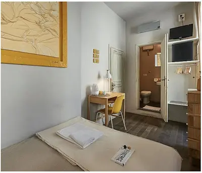 Letto o letti in una camera di BBH Firenze