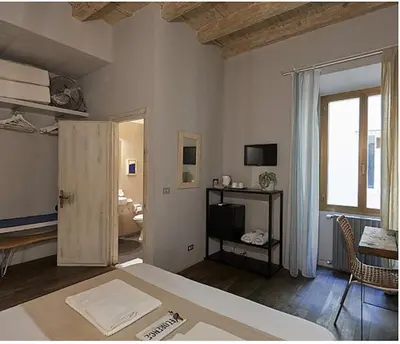 Letto o letti in una camera di BBH Firenze