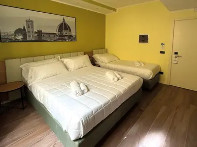 Letto o letti in una camera di JR Hotels Hermes Firenze