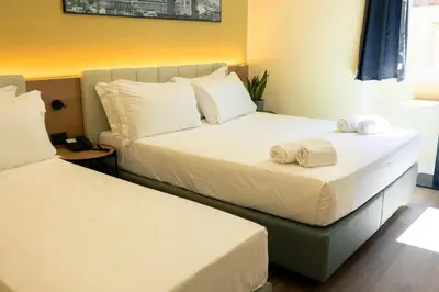 Letto o letti in una camera di JR Hotels Hermes Firenze