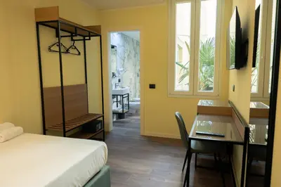 Letto o letti in una camera di JR Hotels Hermes Firenze
