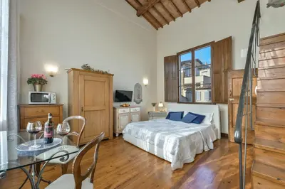 Letto o letti in una camera di Palazzo Uguccioni Apartments