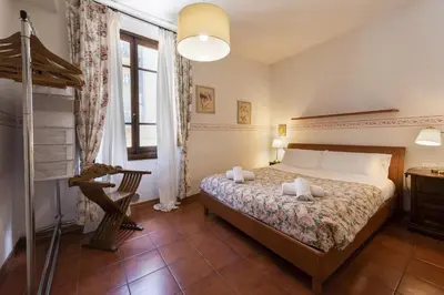 Letto o letti in una camera di Grazioso Appartamento in Oltrarno a Firenze