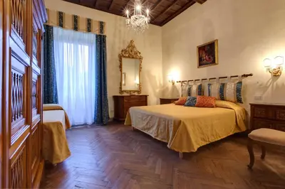 Letto o letti in una camera di Palazzo Bucciolini