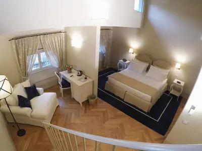 Letto o letti in una camera di Palazzo della Stufa Residenza D'Epoca