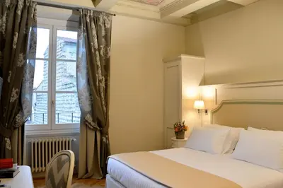 Letto o letti in una camera di Palazzo della Stufa Residenza D'Epoca