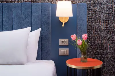 Letto o letti in una camera di NH Firenze