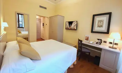 Letto o letti in una camera di B&B La Signoria Di Firenze
