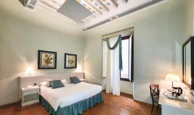 Letto o letti in una camera di B&B La Signoria Di Firenze