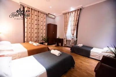 Letto o letti in una camera di Hotel Aida