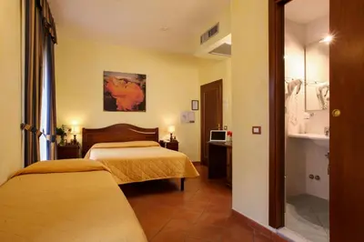 Letto o letti in una camera di Hotel Bologna