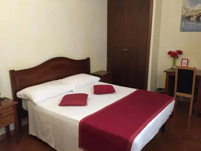 Letto o letti in una camera di Hotel Bologna