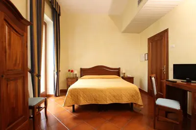 Letto o letti in una camera di Hotel Bologna