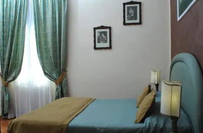 Letto o letti in una camera di Relais Dante e Beatrice