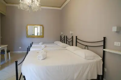 Letto o letti in una camera di Affittacamere ALBA