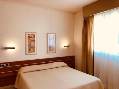 Letto o letti in una camera di Hotel Delfina