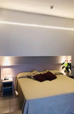 Letto o letti in una camera di Hotel Delfina