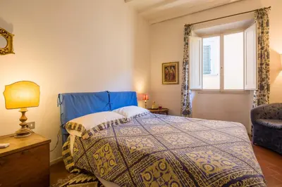 Letto o letti in una camera di Typical Florentine Apartment