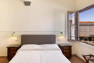 Letto o letti in una camera di B&B Soggiorno Battistero