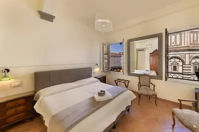 Letto o letti in una camera di B&B Soggiorno Battistero