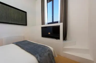 Letto o letti in una camera di B&B Soggiorno Battistero